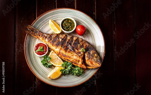 grill fish on plate top view. fried fish top view