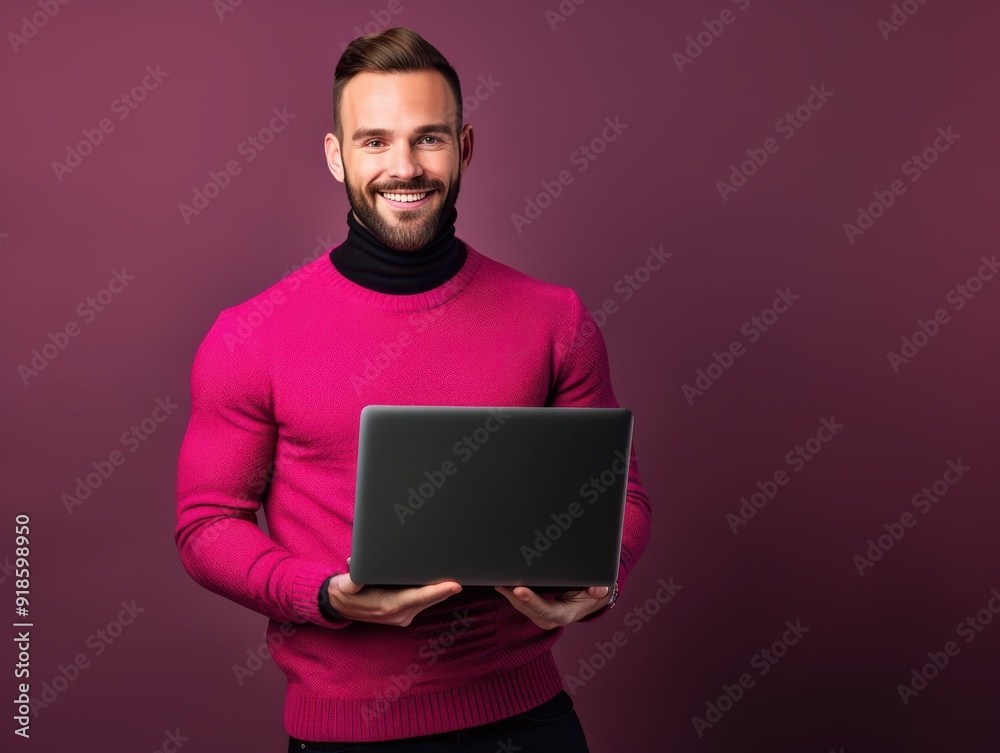 Smiling male architect working on a laptop indoors Smiling male architect working on a laptop indoors
