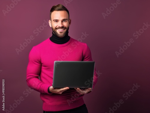 Smiling male architect working on a laptop indoors