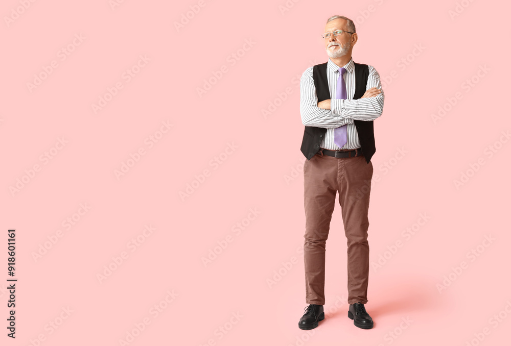 Handsome happy mature man with stylish tie on pink background Handsome happy mature man with stylish tie on pink background