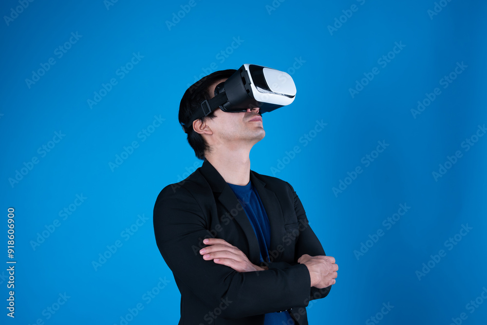 Profile of businessman arm crossing with wearing VR device looking to connect metaverse isolated blue background futuristic analytics communication technology virtual reality copyspace. Contrivance.