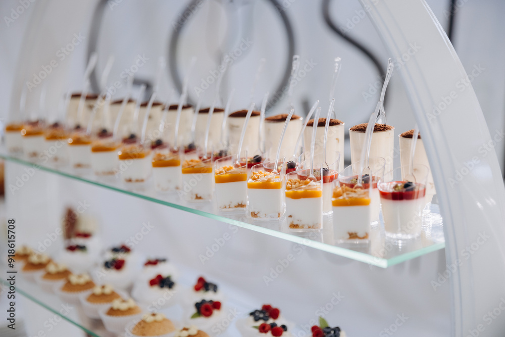 Set of delicious sweet cakes and dessert in the restaurant. Scene is celebratory and festive Set of delicious sweet cakes and dessert in the restaurant. Scene is celebratory and festive