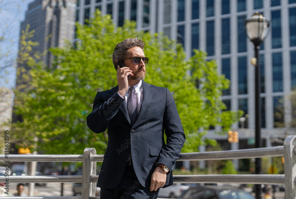 Business communication. Business man having phone call outdoor. Businessman using phone. Man phone conversation in suit. Middle aged Hispanic businessman with phone. Feedback loop Business communication. Business man having phone call outdoor. Businessman using phone. Man phone conversation in suit. Middle aged Hispanic businessman with phone. Feedback loop