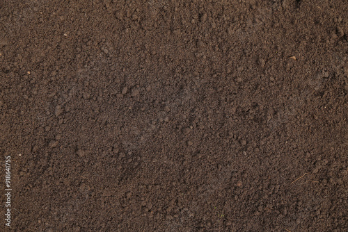 Brown dark soil ground abstract texture background with copyspace top view