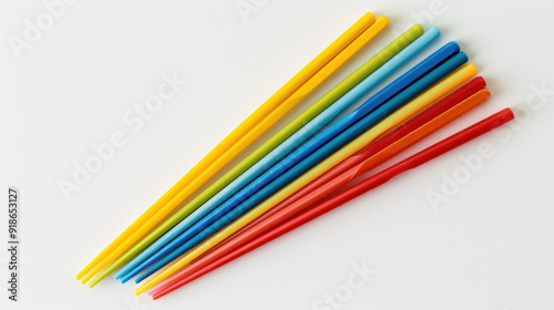 Set of colorful reusable plastic chopsticks cut out on a white background.