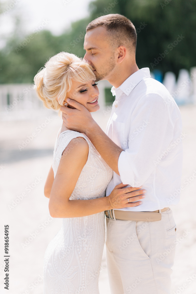 Romantic Couple Embracing on a Sandy Beach in Summer Romantic Couple Embracing on a Sandy Beach in Summer