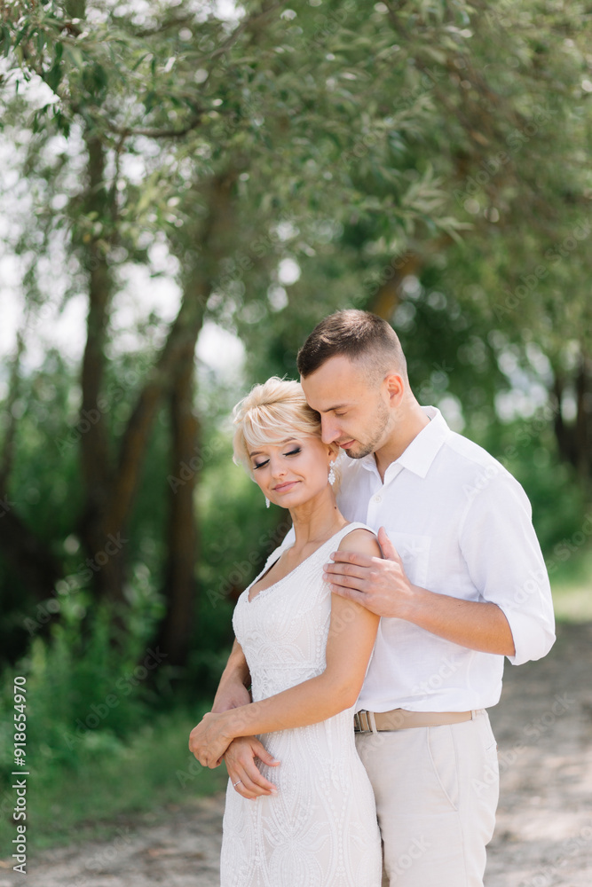 Happy Newlywed Couple Embracing in Nature on Their Wedding Day