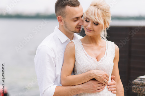 Romantic Couple Sharing an Embrace on Their Wedding Day by the Waterfront