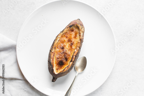 Fotografie Overhead view of sweet potato crème brûlée on a white plate, top view of a sweet