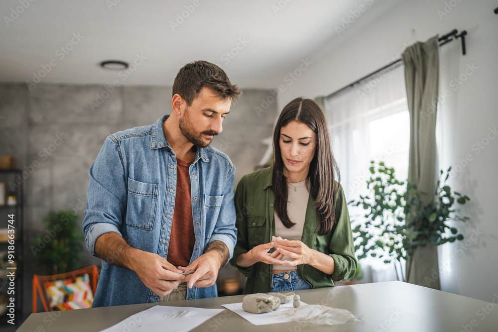 Couple learn and practice how to make a clay figurine, pottery Couple learn and practice how to make a clay figurine, pottery