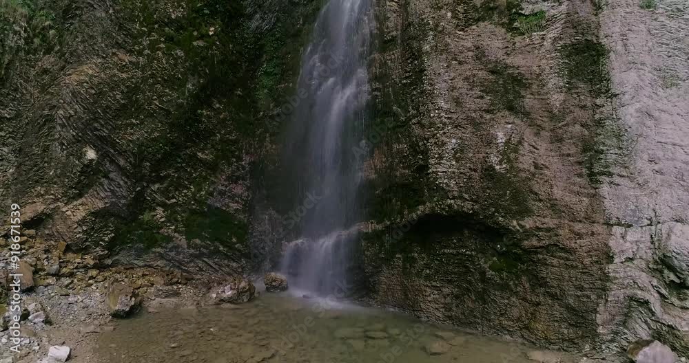 Aerial drone Brinta Waterfall hidden inside the forest, 4k.beauties of Slovenia to be discovered. Near Nova Gorica. Water spray, vivid rainbow forms from the waterfall that falls sheer onto the rock. Aerial drone Brinta Waterfall hidden inside the forest, 4k.beauties of Slovenia to be discovered. Near Nova Gorica. Water spray, vivid rainbow forms from the waterfall that falls sheer onto the rock.