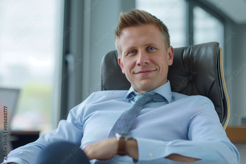 A businessman with a friendly smile sitting comfortably in a modern office chair, conveying confidence and relaxation A businessman with a friendly smile sitting comfortably in a modern office chair, conveying confidence and relaxation