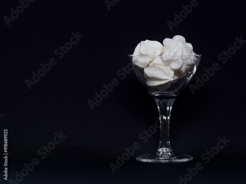 Tokyo, Japan -August 12, 2024: Closeup of Meringue Cookies in a glass on black background