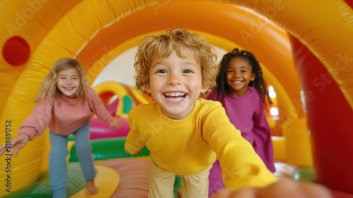 Wallpaper Mural Three children are having fun, laughing and bouncing inside a vibrant inflatable bounce house Torontodigital.ca