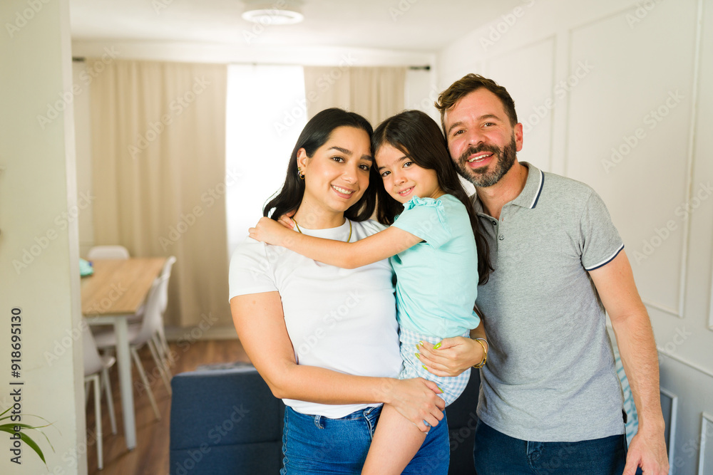 Latin family is enjoying quality time together, laughing and hugging in their cozy living room Latin family is enjoying quality time together, laughing and hugging in their cozy living room