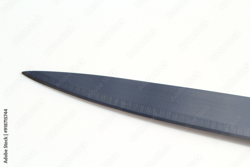 Close-up of a knife blade kitchen utensil against a white background Close-up of a knife blade kitchen utensil against a white background
