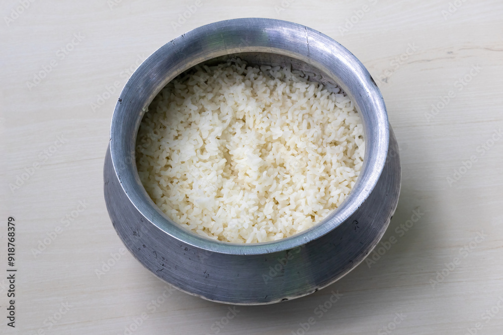 Cooked white rice in a silverware. Rice is a staple food in Bangladesh. Plain rice have more nutrients like fiber and vitamins. A container that holds cooked white rice that ready to eat. Cooked white rice in a silverware. Rice is a staple food in Bangladesh. Plain rice have more nutrients like fiber and vitamins. A container that holds cooked white rice that ready to eat.