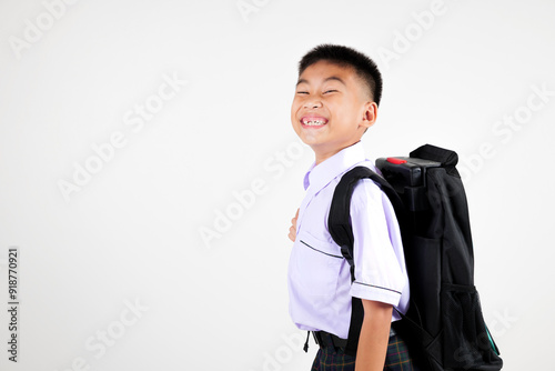 Portrait smile Asian little boy primary posing with schoolbag phone studio shot isolated white background, happy cute man kid wear school uniform and backpack learn new things, back to school concept