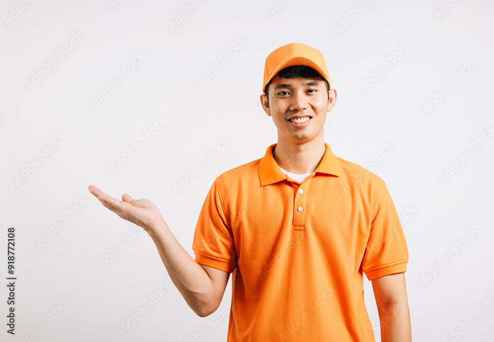 Portrait Asian smiling young delivery man showing something with empty open palm hands studio isolated white background, Happy lifestyle men carry person in an orange shirt uniform Portrait Asian smiling young delivery man showing something with empty open palm hands studio isolated white background, Happy lifestyle men carry person in an orange shirt uniform