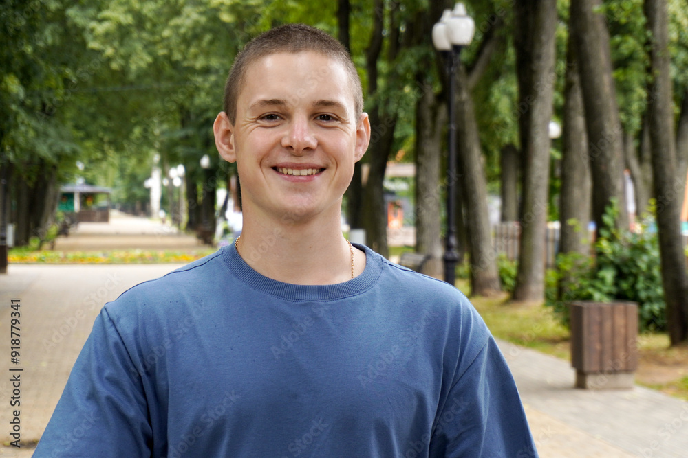 smiling handsome young man on a walk in a summer park. smiling handsome young man on a walk in a summer park.