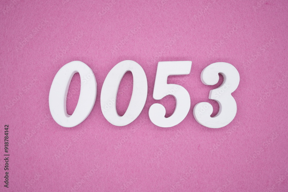 The numbers are made of white painted wood. Laying on the floor was pink paper. The numbers are made of white painted wood. Laying on the floor was pink paper.