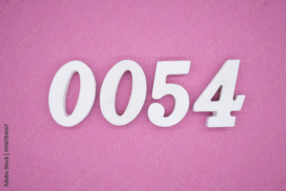 The numbers are made of white painted wood. Laying on the floor was pink paper. The numbers are made of white painted wood. Laying on the floor was pink paper.
