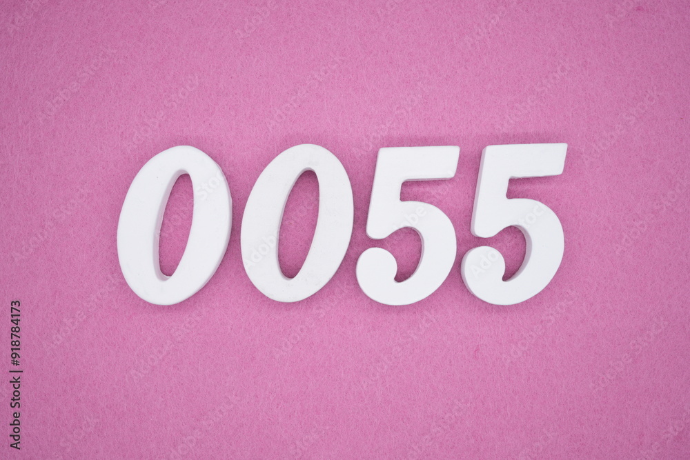 The numbers are made of white painted wood. Laying on the floor was pink paper. The numbers are made of white painted wood. Laying on the floor was pink paper.