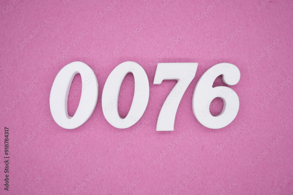 The numbers are made of white painted wood. Laying on the floor was pink paper. The numbers are made of white painted wood. Laying on the floor was pink paper.