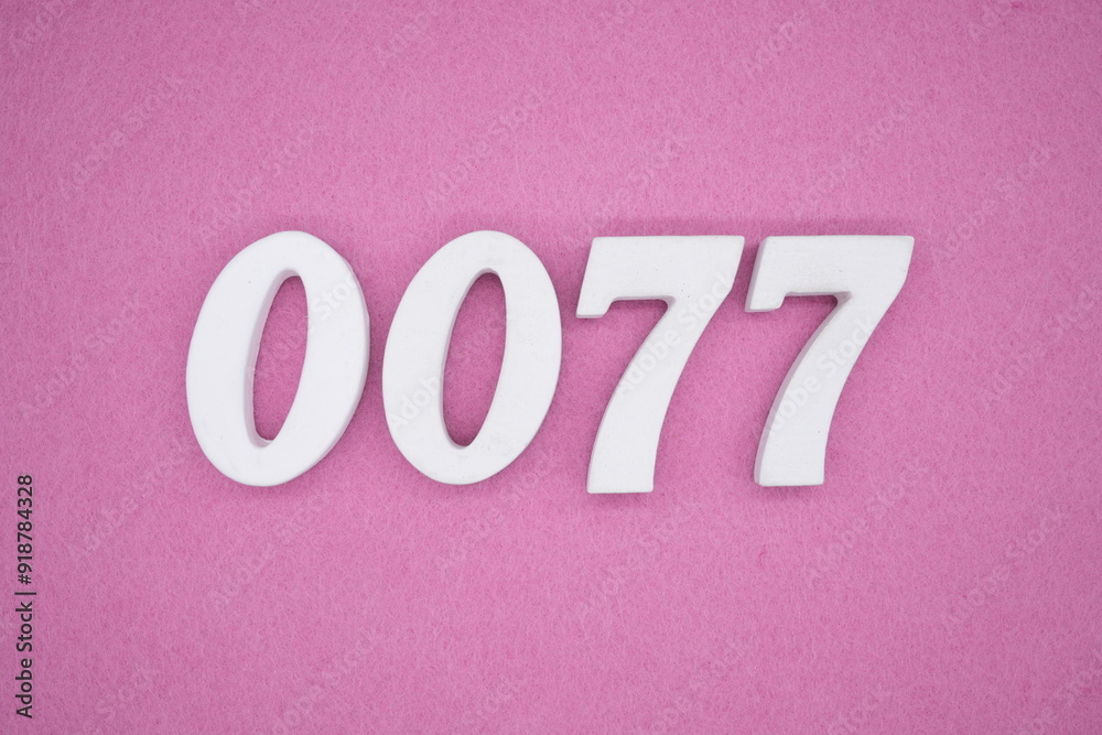 The numbers are made of white painted wood. Laying on the floor was pink paper. The numbers are made of white painted wood. Laying on the floor was pink paper.