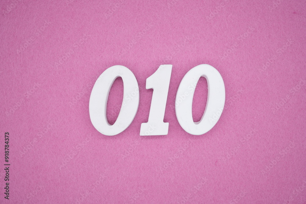 The numbers are made of white painted wood. Laying on the floor was pink paper. The numbers are made of white painted wood. Laying on the floor was pink paper.