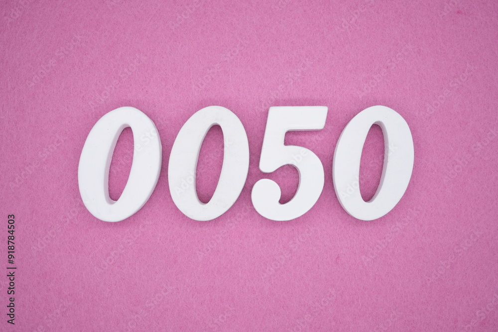 The numbers are made of white painted wood. Laying on the floor was pink paper. The numbers are made of white painted wood. Laying on the floor was pink paper.