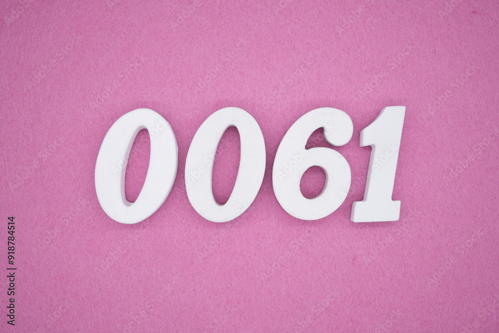 The numbers are made of white painted wood. Laying on the floor was pink paper. The numbers are made of white painted wood. Laying on the floor was pink paper.