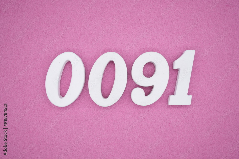 The numbers are made of white painted wood. Laying on the floor was pink paper. The numbers are made of white painted wood. Laying on the floor was pink paper.