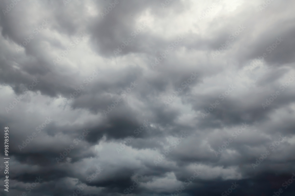 Dark dramatic sky with black stormy clouds before rain or snow as abstract background, extreme weather Dark dramatic sky with black stormy clouds before rain or snow as abstract background, extreme weather