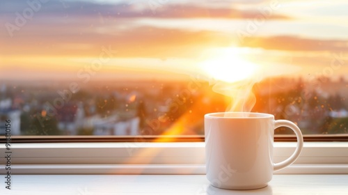 A steaming mug of coffee rests on a windowsill, offering a peaceful view of the sunset illuminating the sky