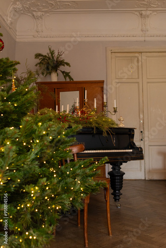 Christmas tree with bright lights garland in living room with vintage interior and piano, New year celebration. Xmas home decoration, vertical