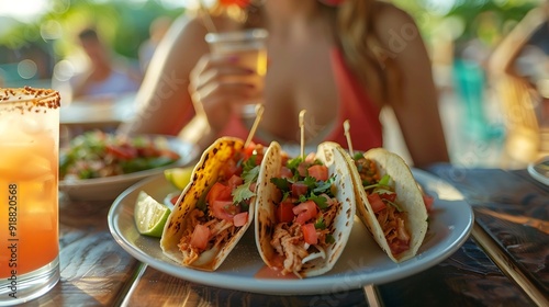 Closeup of a woman sitting at a table outdoors on a restaurant patio and eating a plate of delicious tacos with a drink : Generative AI