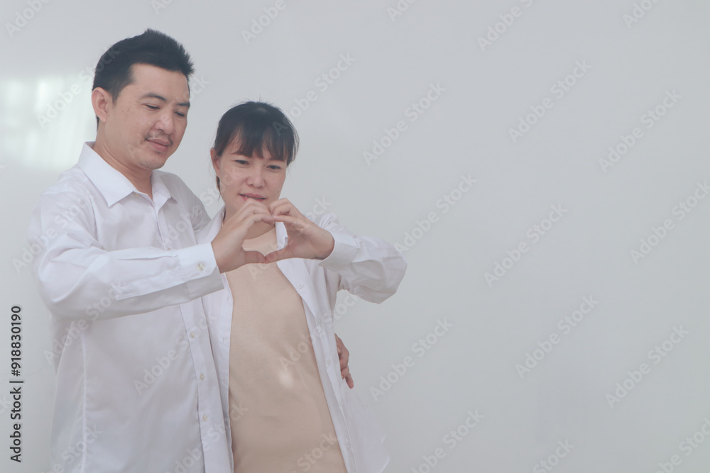 Asian couple celebrates Valentine's Day with joy and love, cherishing their pregnancy as they embrace the happiness of building a family, creating memories of a lifetime together. Asian couple celebrates Valentine's Day with joy and love, cherishing their pregnancy as they embrace the happiness of building a family, creating memories of a lifetime together.