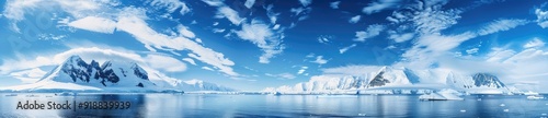 Snowy Mountain Range and Blue Sky over Water