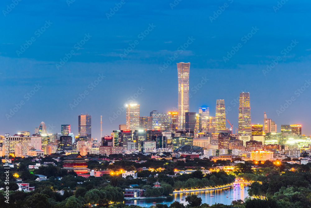 Obraz premium High angle night view of Guomao CBD and Bell and Drum Tower in Beijing, China