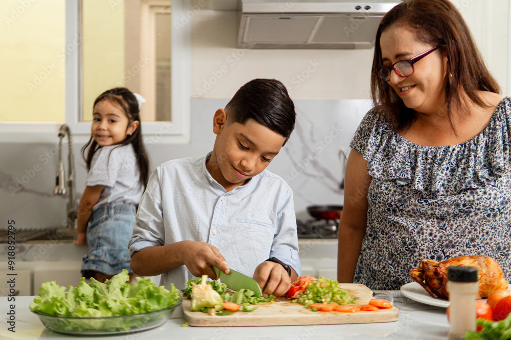 Grandmother helping to her grandchild to cutting lettuce. Grandmother helping to her grandchild to cutting lettuce.