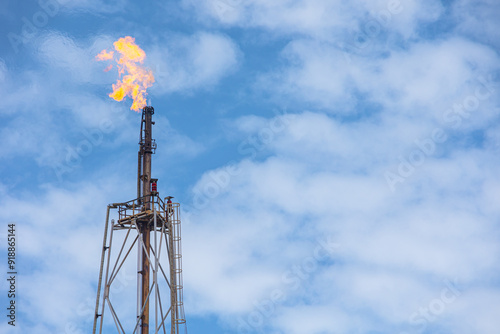 Methane Gas Fire High Flare Stack Flaring Tower Platform in Refinery Petroleum Plant or Flame Burn On Offshore Oil Extraction Process.