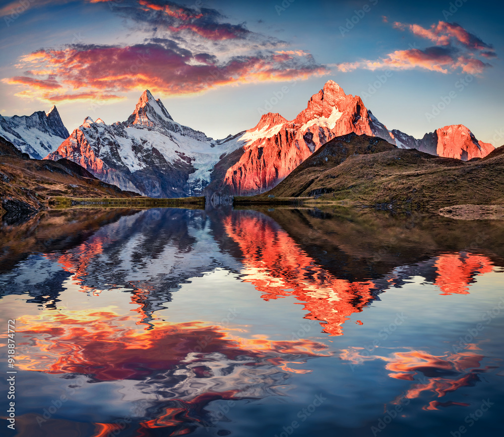 Wetterhorn and Wellhorn peaks reflected in the calm waters of Bachsee lake. Fantastic autumn sunset on Bernese Oberland Alps, Grindelwald location, Innertkirchen, Switzerland, Europe.