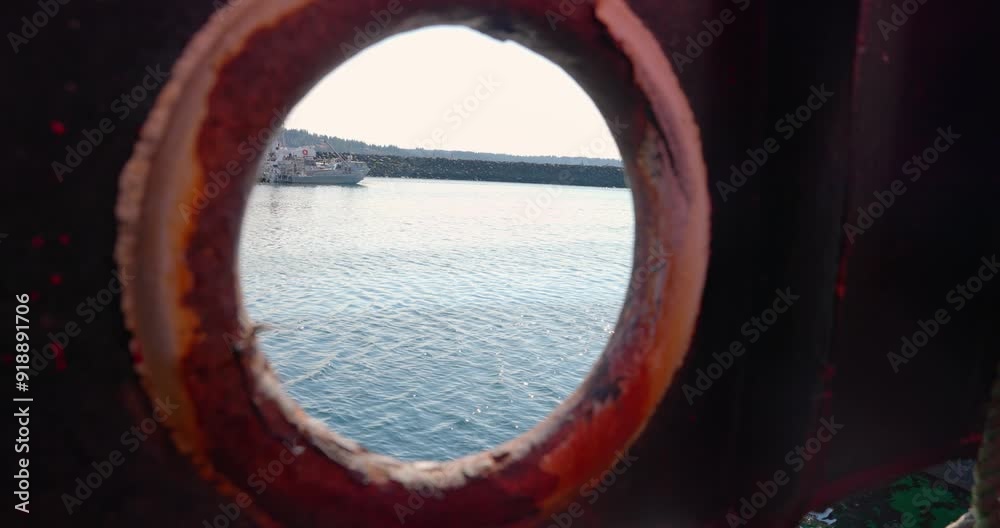 Ocean glimpse through boat's round window