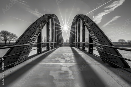 River bridge in Duisburg Ruhr Basin with riveted steel beams from a frog perspective in black and white with sun photo