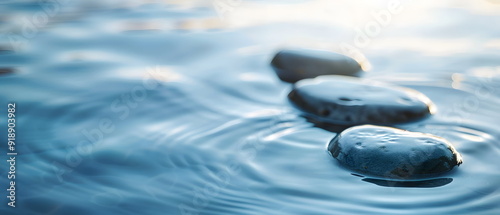 Soothing rhythms and wellbeing banner. Captivating moment of drops and stones dancing in water. Background for website, shop, print design template, paper pattern and space for text.