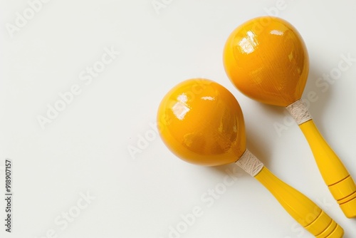 Yellow maracas on white background with space for text