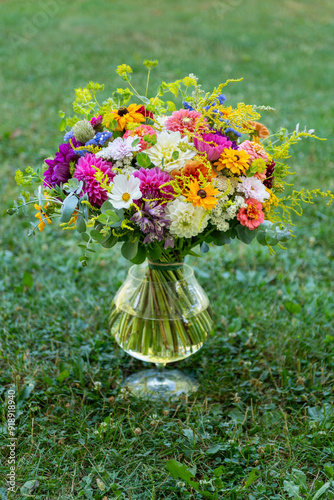 Summer bouquet. Beautiful multi colored fresh flower arrangement. Birthday weddding bouquet made of summer flowers photographed outdoors. photo