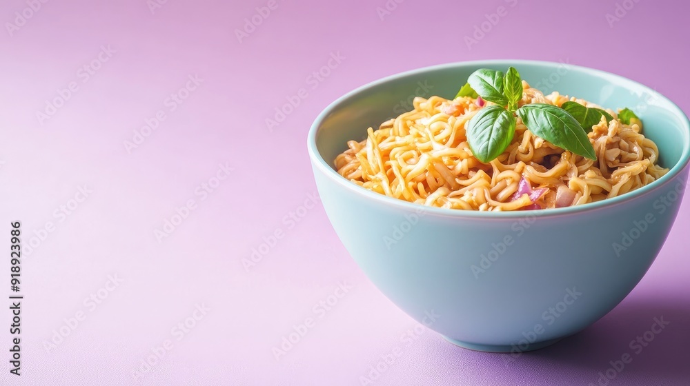 A bowl of pad see ew noodles on a soft purple background with space for text or branding. A bowl of pad see ew noodles on a soft purple background with space for text or branding.