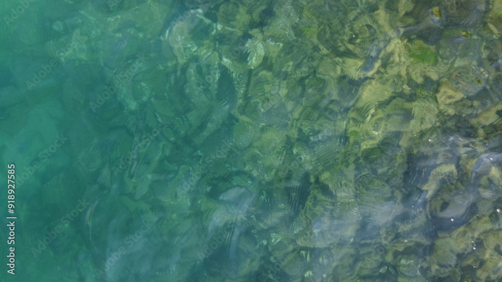 the surface of the sea with a rocky bottom the surface of the sea with a rocky bottom